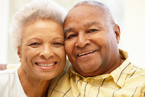 Closeup of senior couple with their heads tilted together and smiling